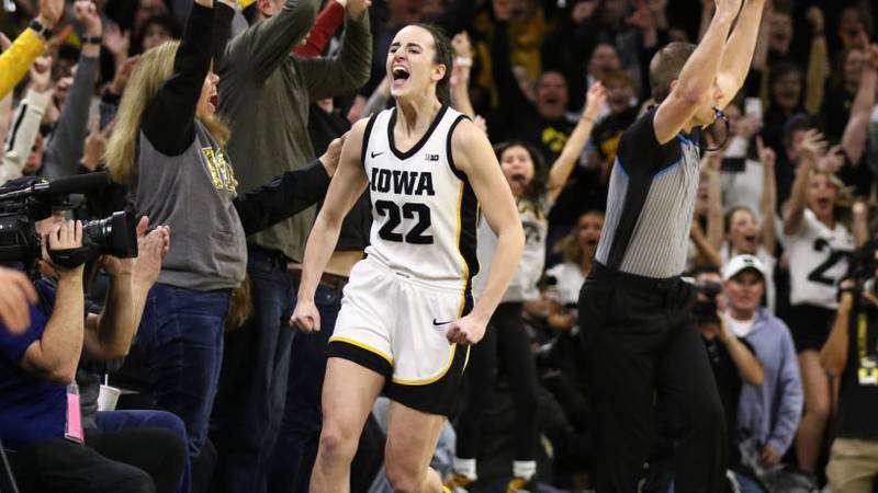 IOWA CITY, IOWA- FEBRUARY 15:  Caitlin Clark #22 of the Iowa Hawkeyes celebrates after breaking the NCAA women's all-time scoring record during the first half against the Michigan Wolverines at Carver-Hawkeye Arena on February 15, 2024 in Iowa City, Iowa.  (Photo by Matthew Holst/Getty Images)